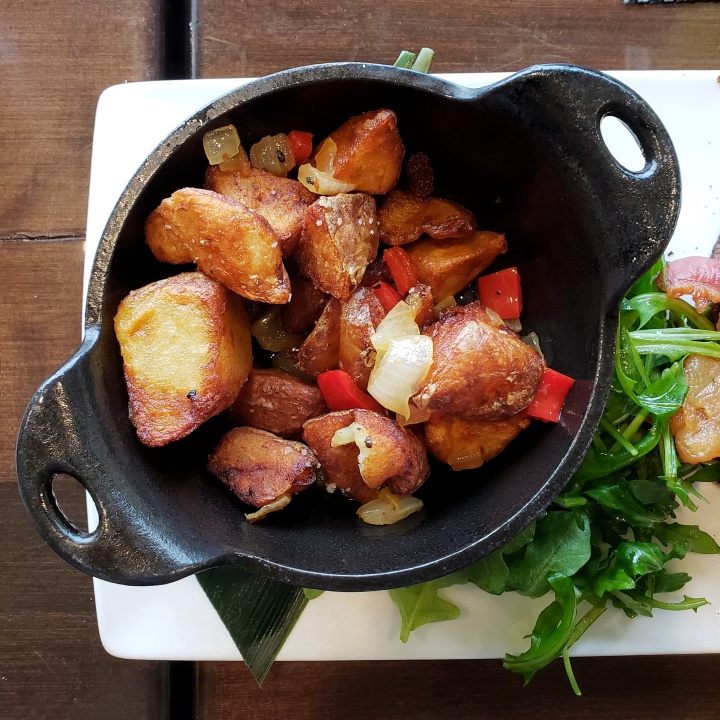 Potatoes (side item with the B.A.E.; potato, onion, and red pepper in cast iron skillet) at Fahrenheit Charlotte brunch in North Carolina